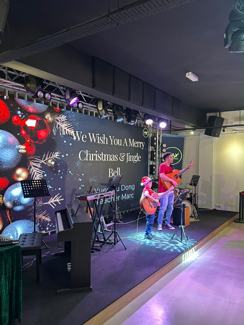 Small acoustic performance on the stage with event lighting at Dreamlive Event Space Puchong