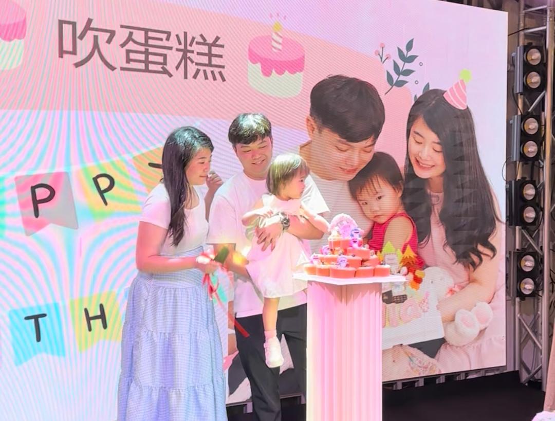 Children's birthday party with family on stage and a themed backdrop on the LED screen at Dreamlive Event Space Puchong