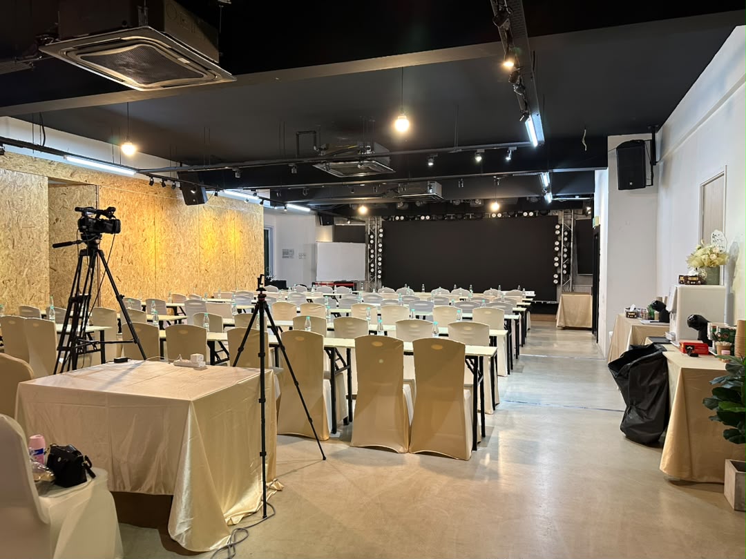 Classroom setup with white tables and chairs ready for a workshop at Dreamlive Event Space Puchong