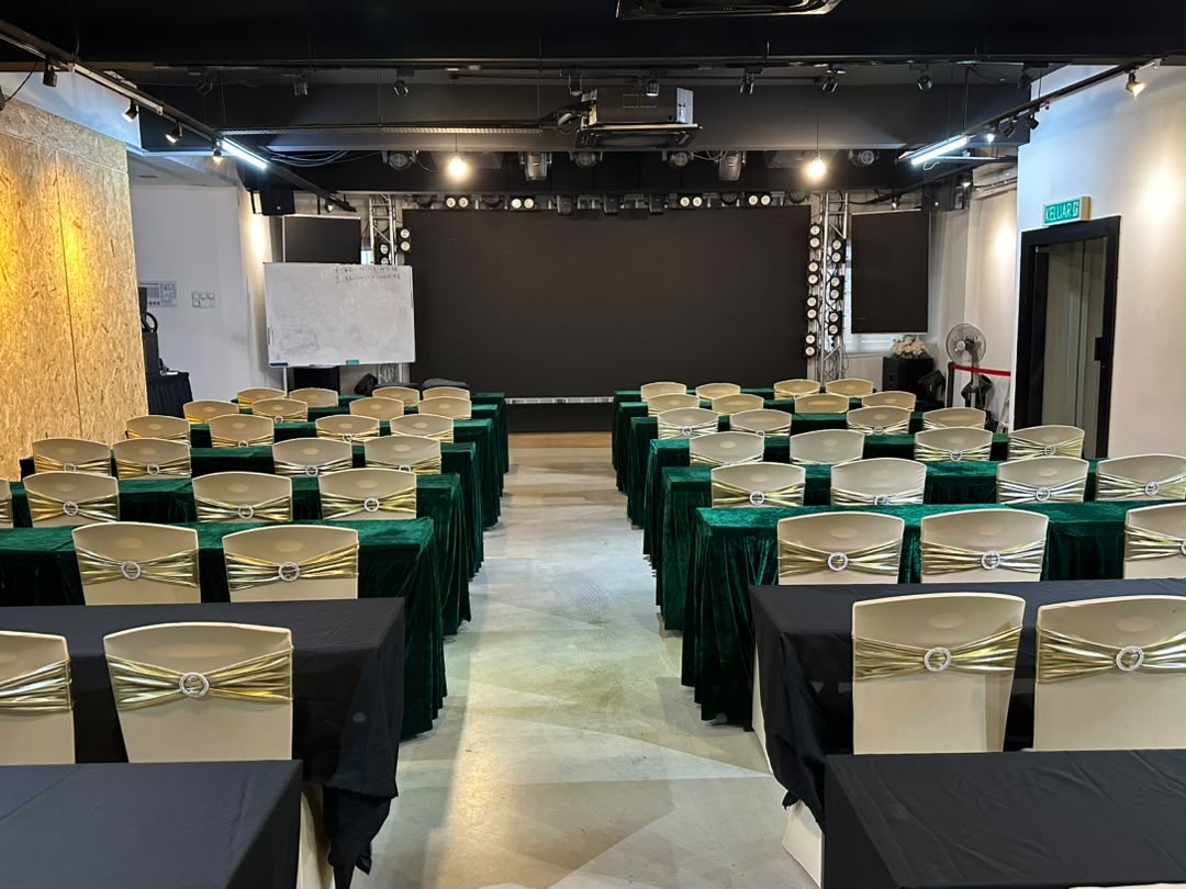 Event hall set up with skirted tables and ribboned chairs before a programme at Dreamlive Event Space Puchong